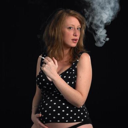 Smoking pregnant dressed