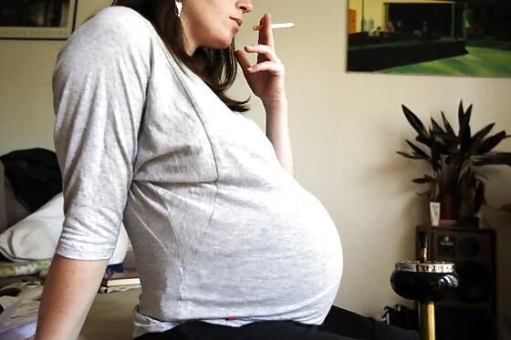 Smoking pregnant dressed