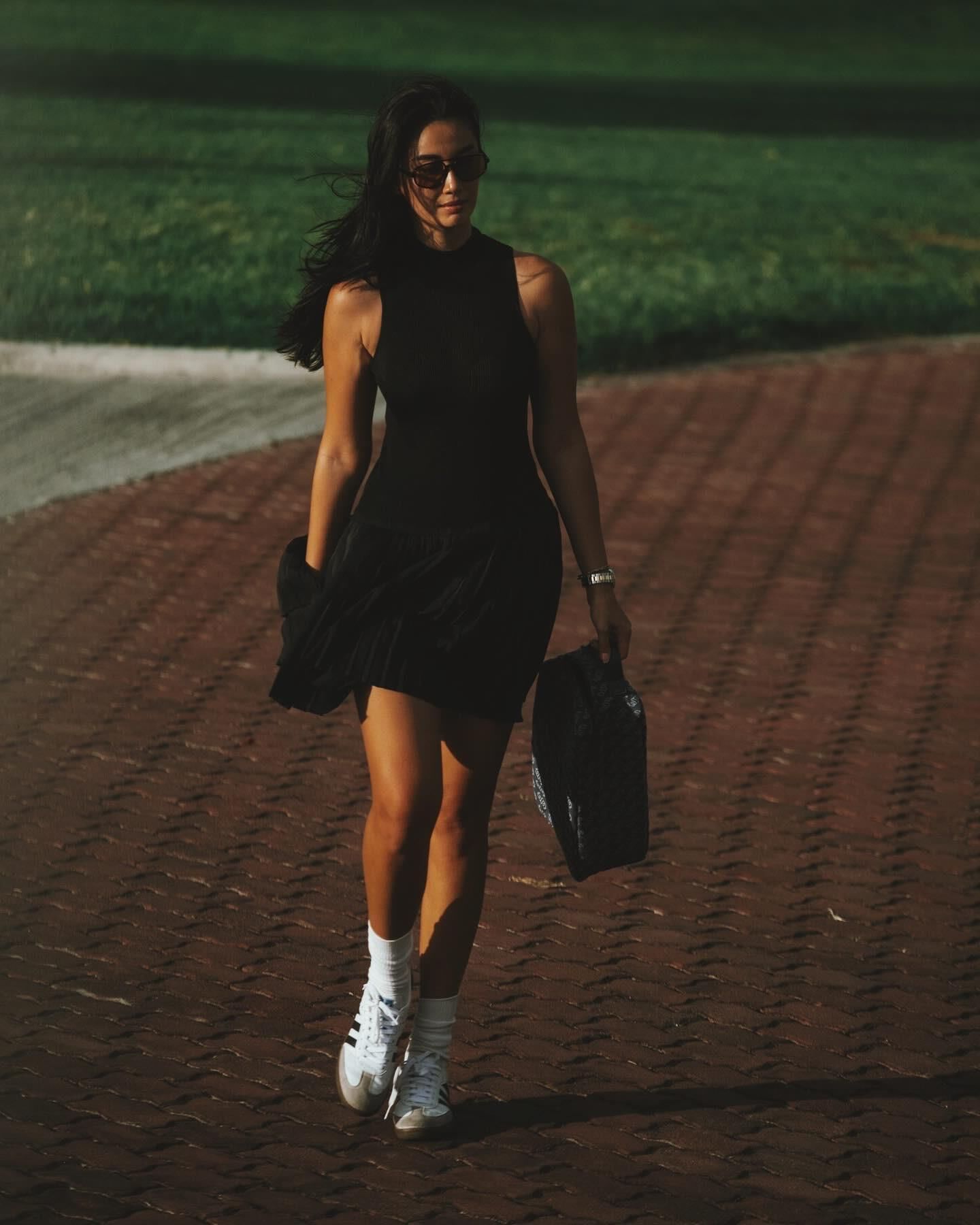 Black sleeveless tops and metal wristwatches #