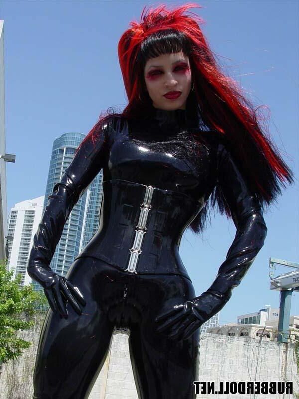 Kinky doll in black latex catsuit and public pussy spreading