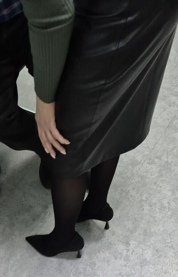 Co worker in leather skirt and suede heels