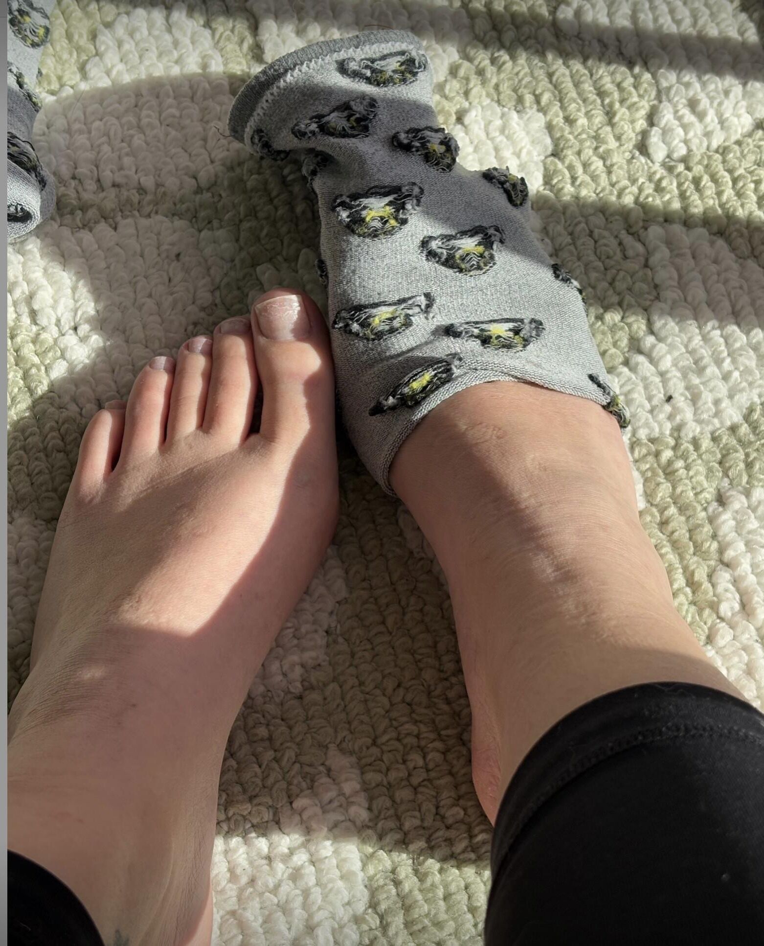 Ash removing socks to expose her no polish toes