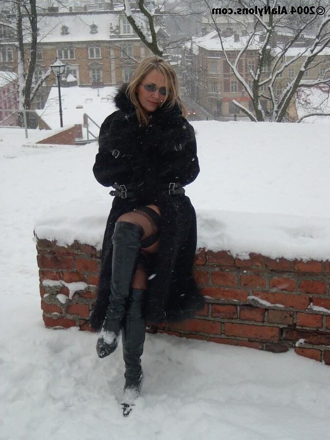 Fur coat, nylons and boots in the snow