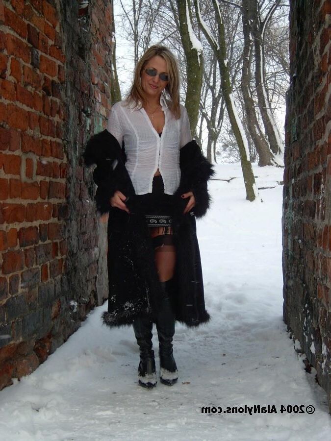 Fur coat, nylons and boots in the snow