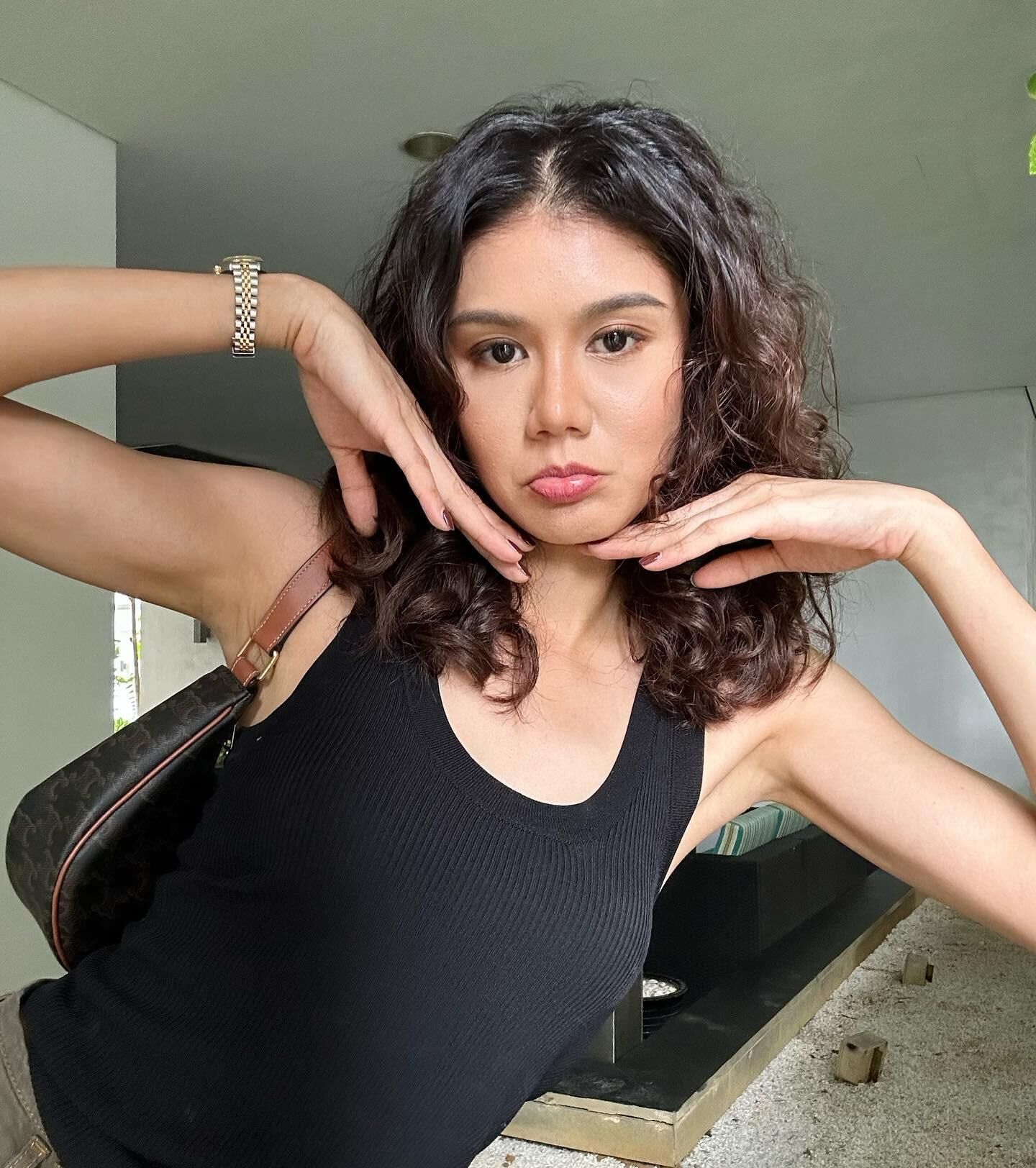 Black sleeveless tops and metal wristwatches #