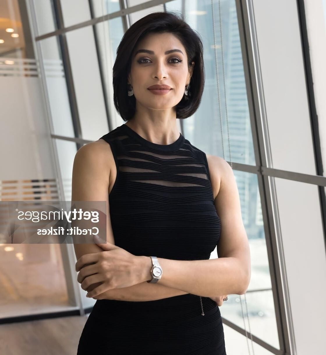 Black sleeveless tops and metal wristwatches #