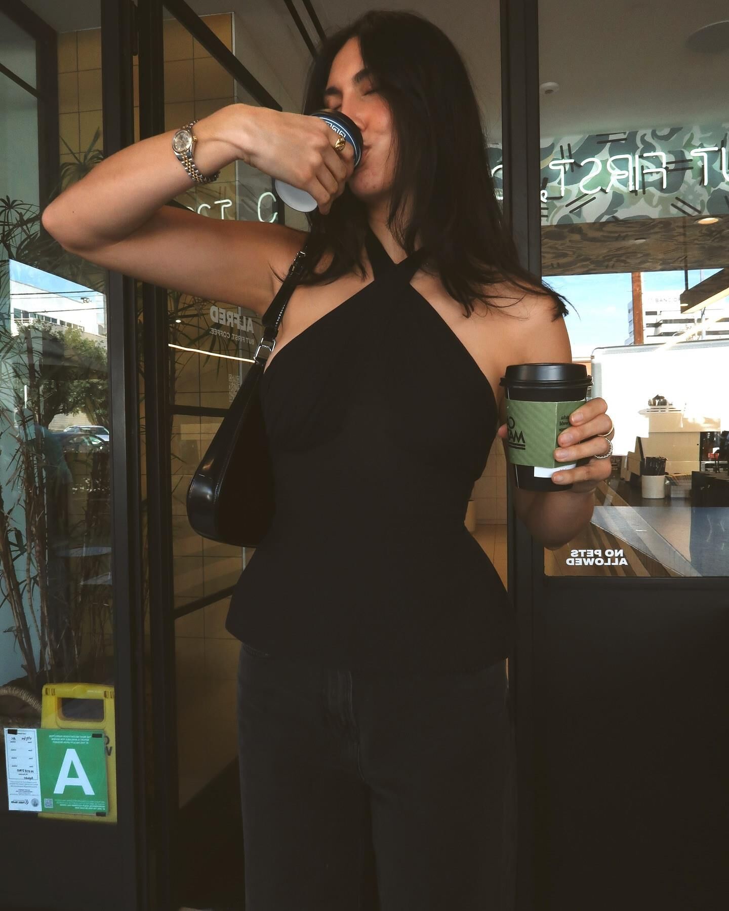 Black sleeveless tops and metal wristwatches #
