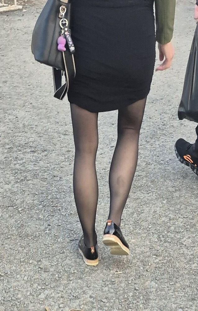 Skinny girl in pantyhose and midi skirt