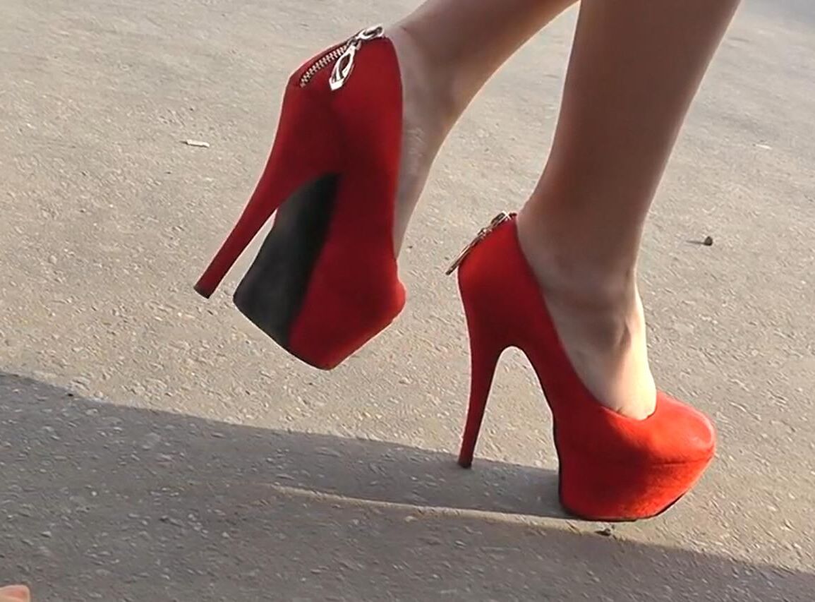 Brunette in red heels under the dress