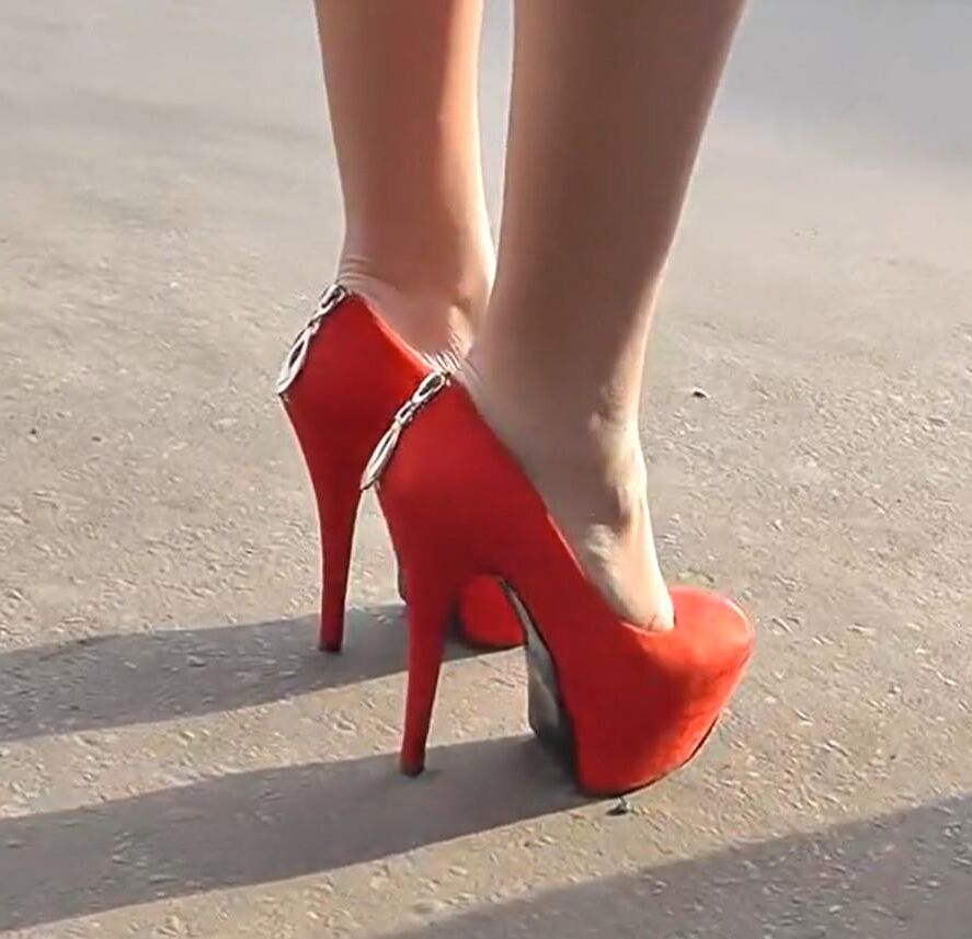 Brunette in red heels under the dress
