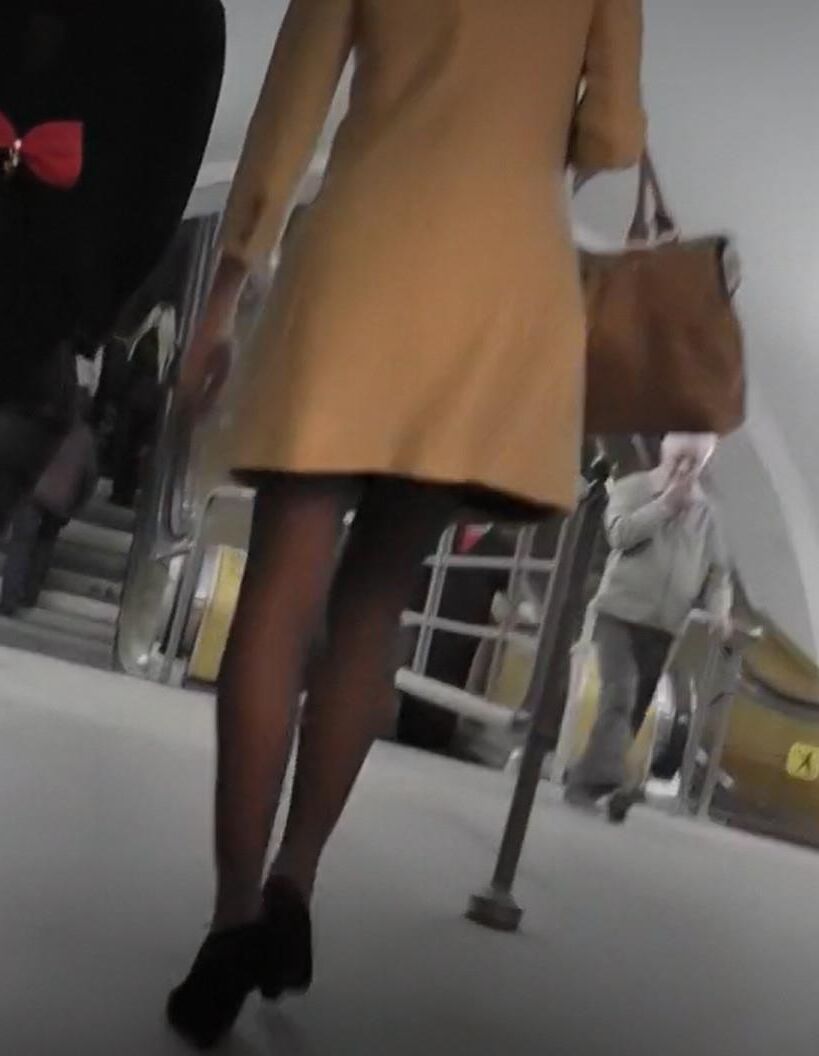Menina de casaco, calcinha bronzeada e botas de tornozelo de camurça