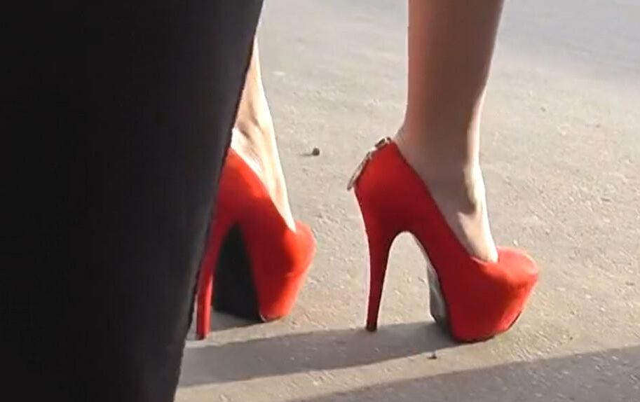 Brunette in red heels under the dress