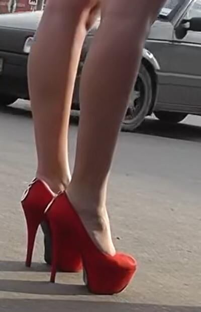 Brunette in red heels under the dress