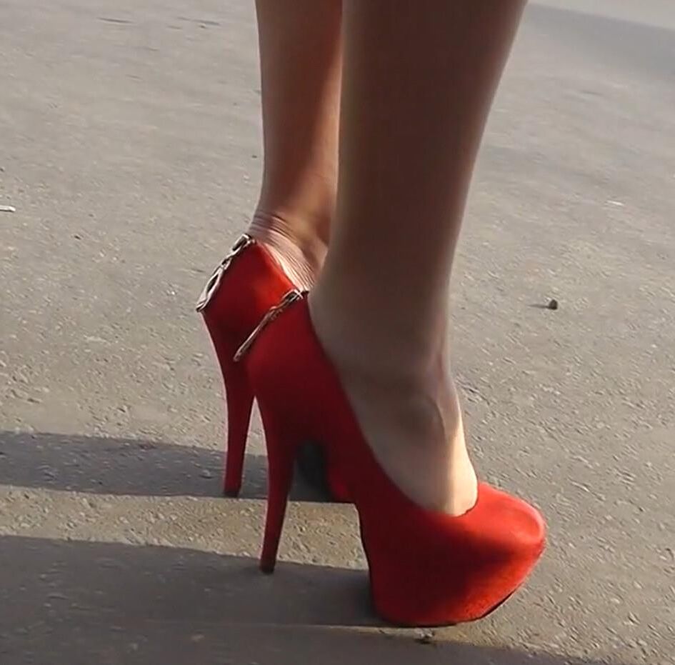 Brunette in red heels under the dress