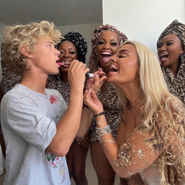 Black women feminizing white boys with lipstick