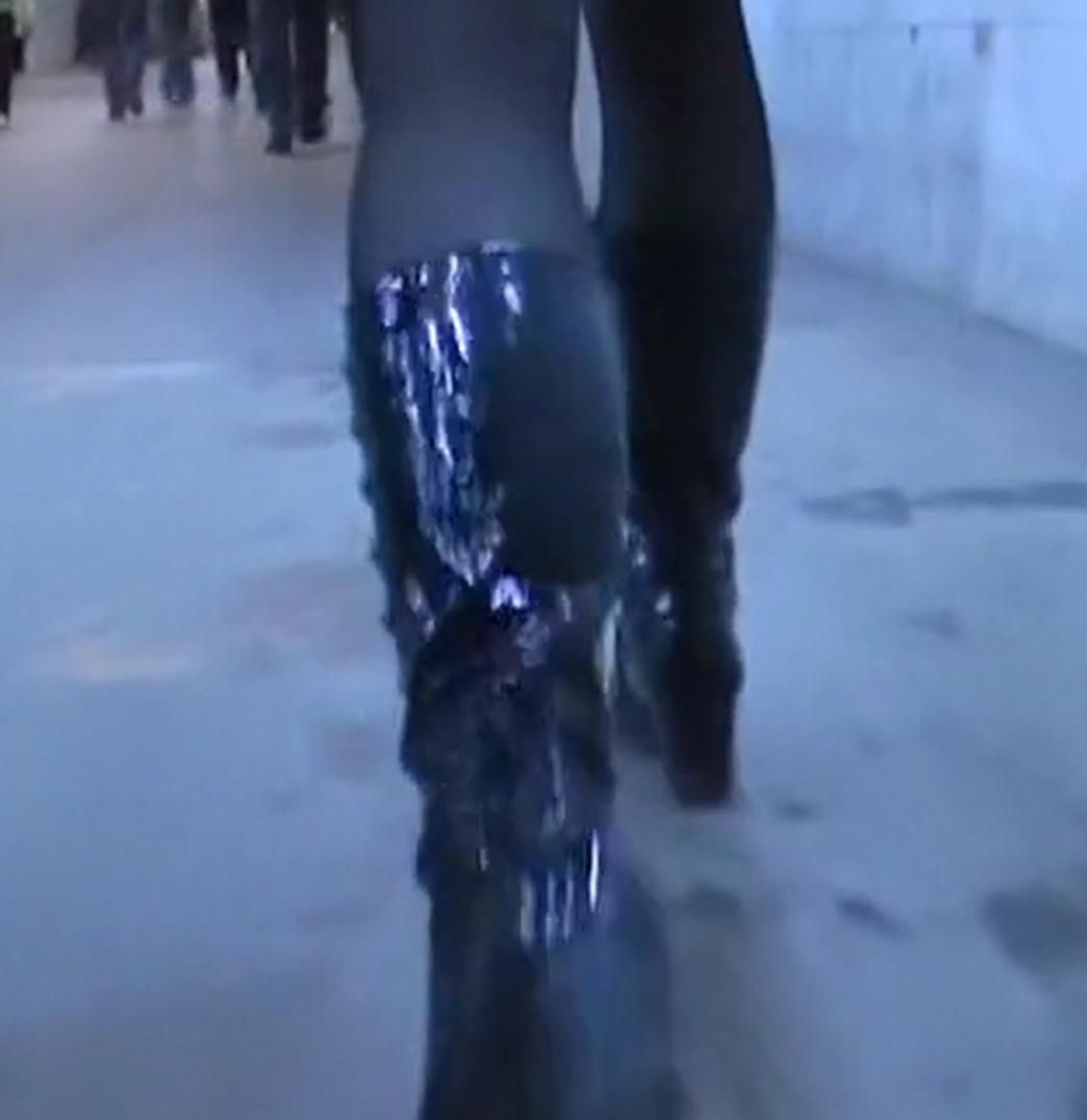 Upskirt girl in black pantyhose and patent leather boots