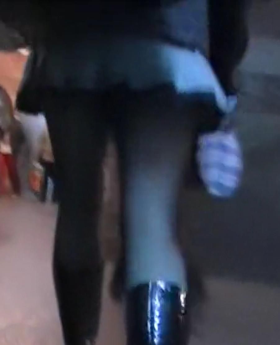 Upskirt girl in black pantyhose and patent leather boots