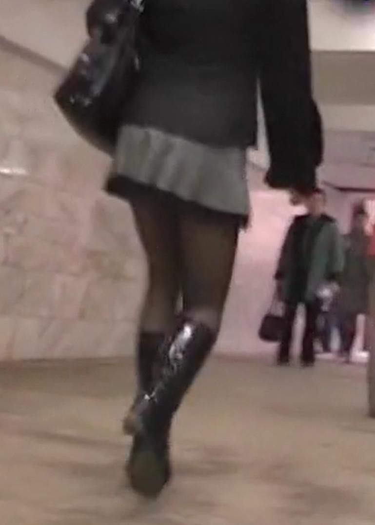 Upskirt girl in black pantyhose and patent leather boots
