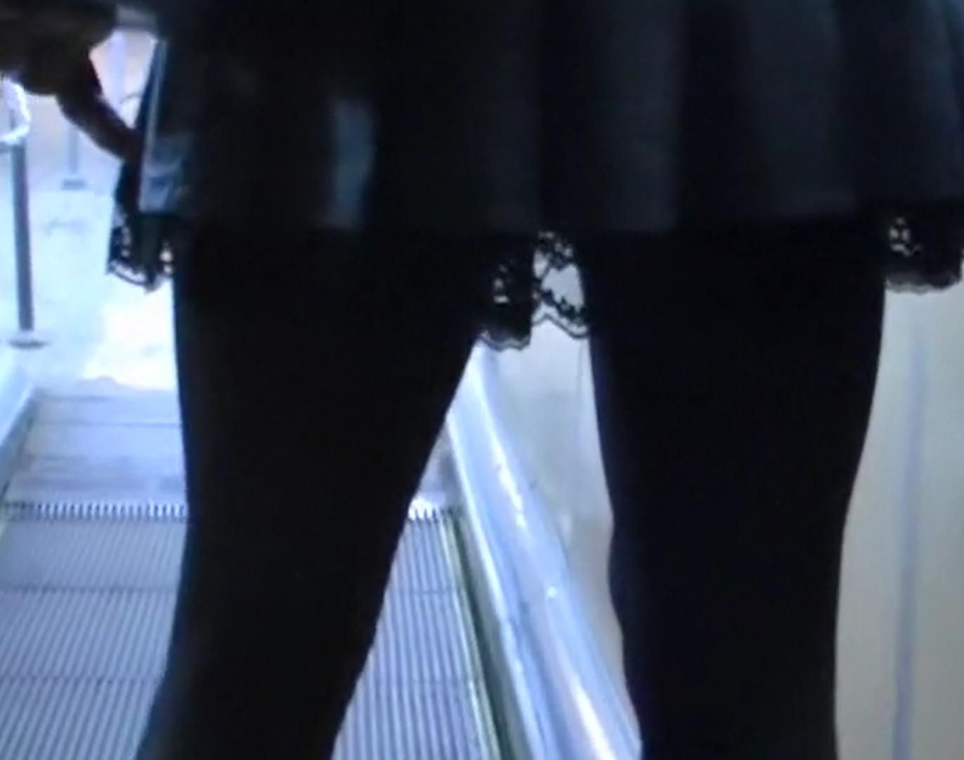 Upskirt girl in black pantyhose and patent leather boots