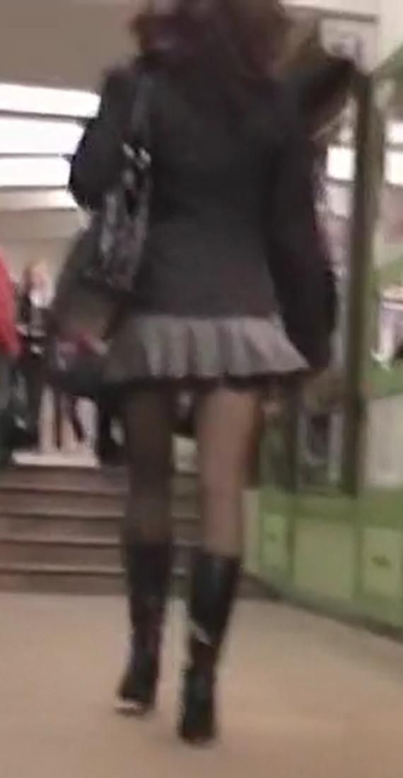 Upskirt girl in black pantyhose and patent leather boots