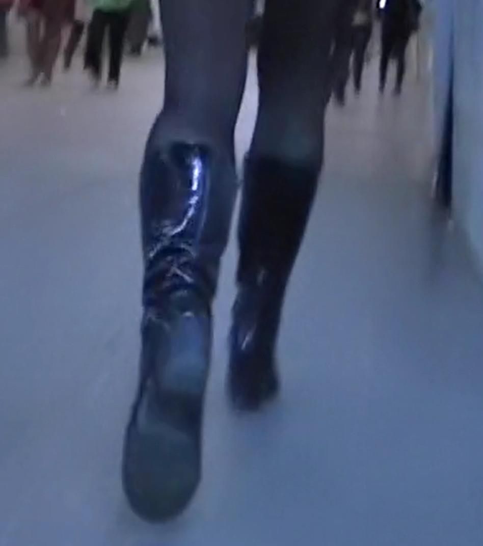 Upskirt girl in black pantyhose and patent leather boots