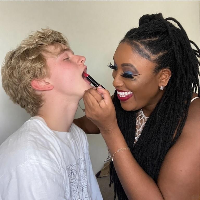 Black women feminizing white boys with lipstick