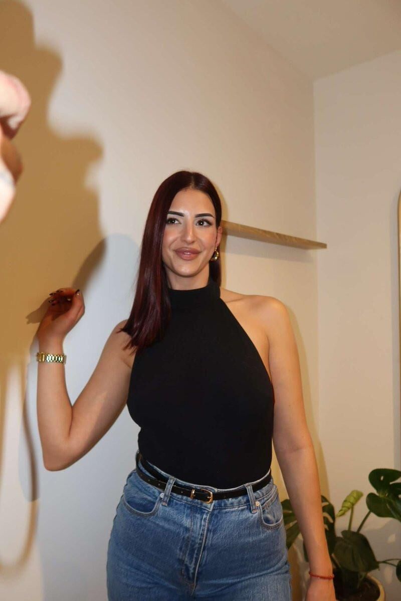 Black sleeveless tops and metal wristwatches #