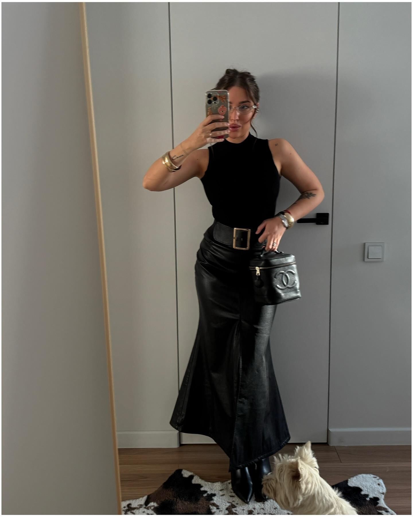 Black sleeveless tops and metal wristwatches #