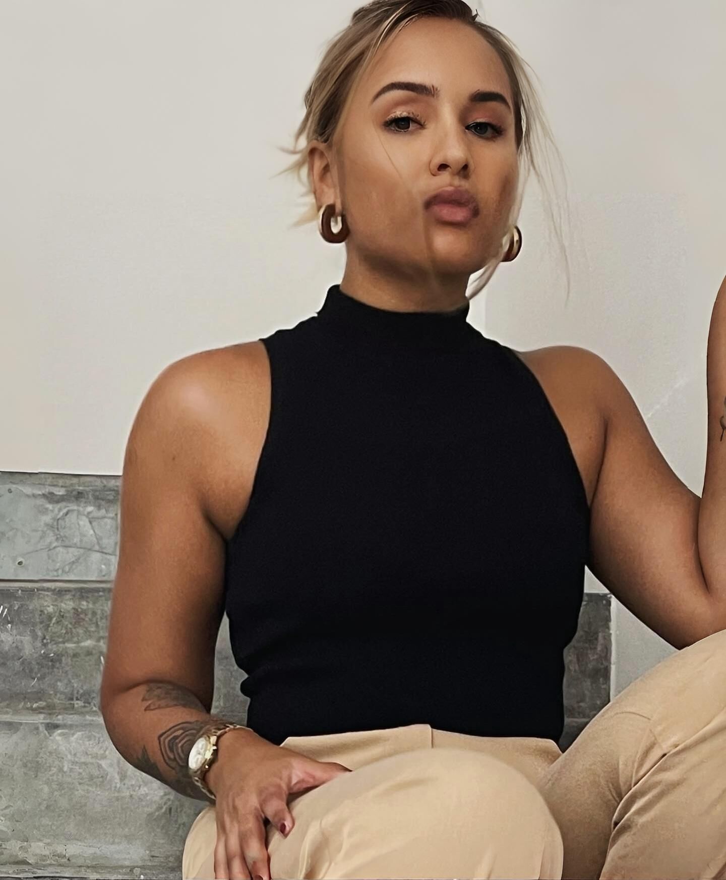 Black sleeveless tops and metal wristwatches #