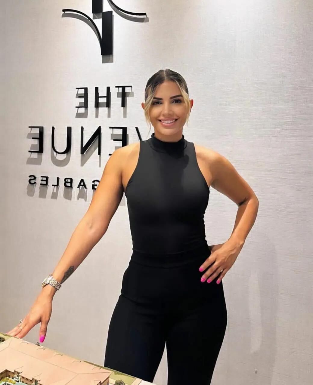 Black sleeveless tops and metal wristwatches #