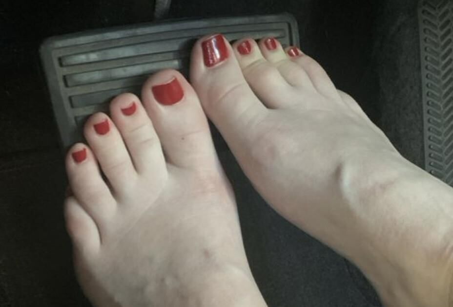 Heather removing her sweaty Converse in the car
