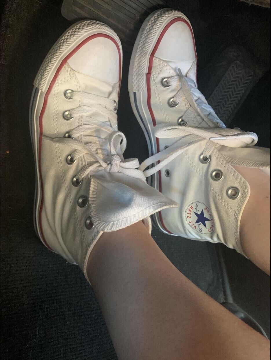 Heather removing her sweaty Converse in the car