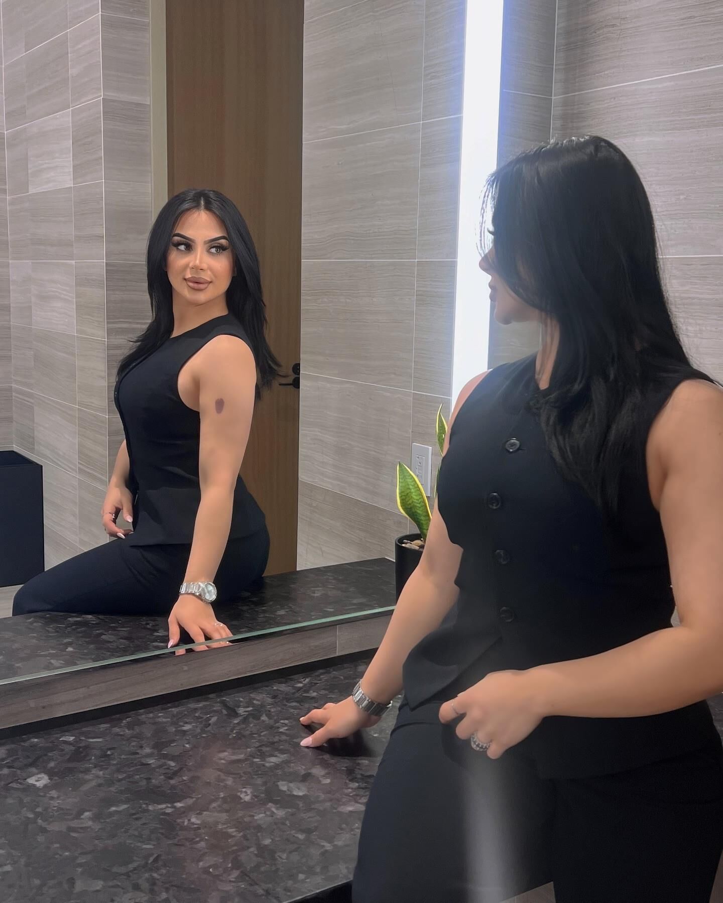 Black sleeveless tops and metal wristwatches #