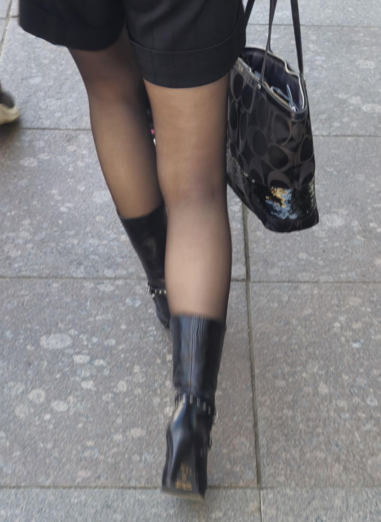 Girl in black pantyhose and leather boots
