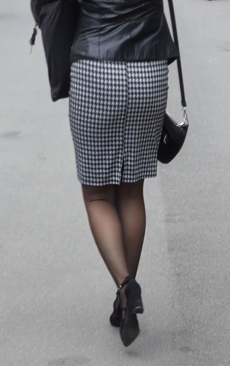 Business woman in midi skirt, pantyhose and suede heels