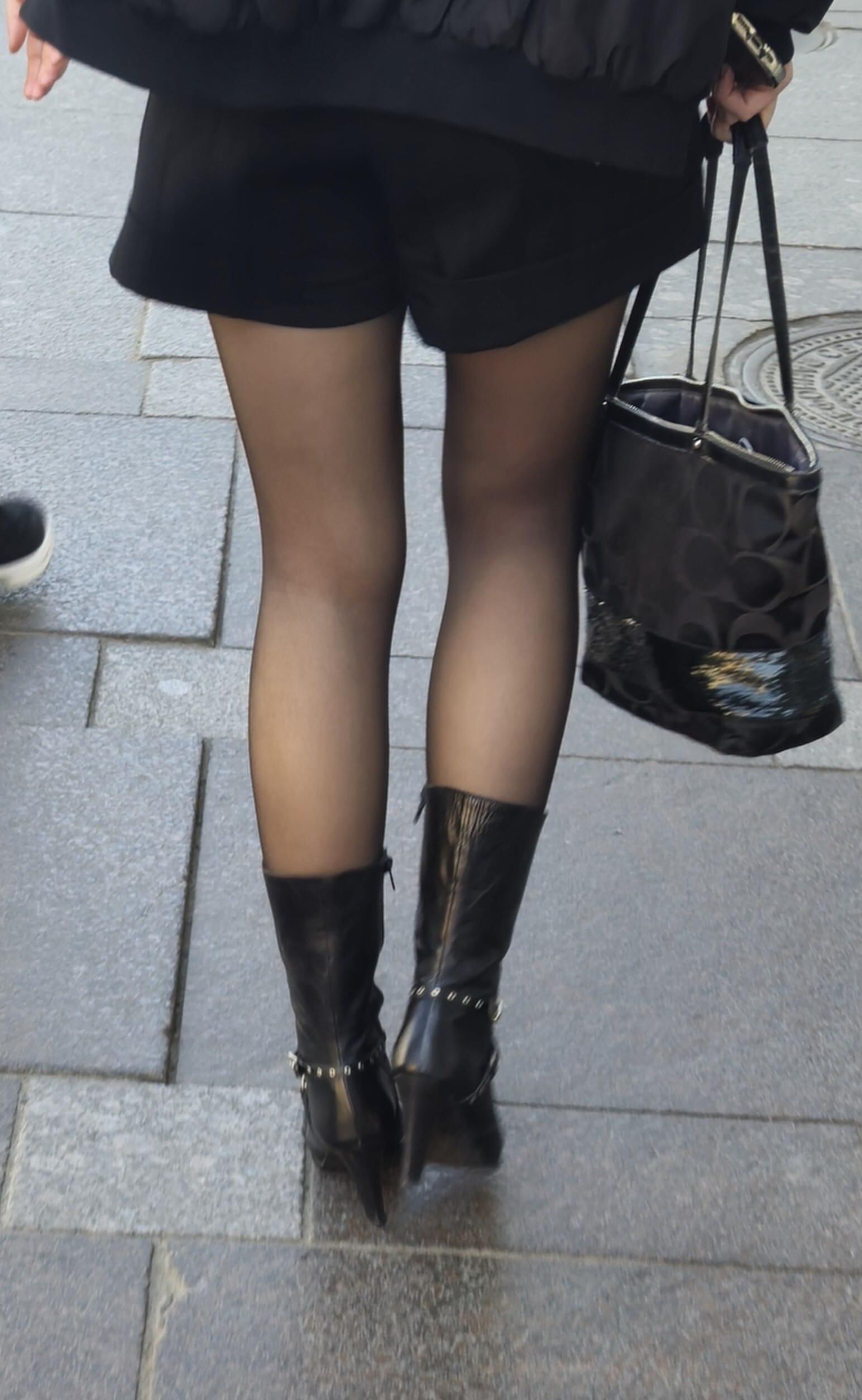 Girl in black pantyhose and leather boots