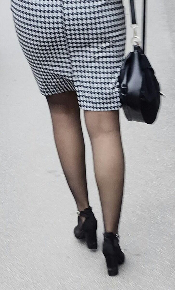 Business woman in midi skirt, pantyhose and suede heels