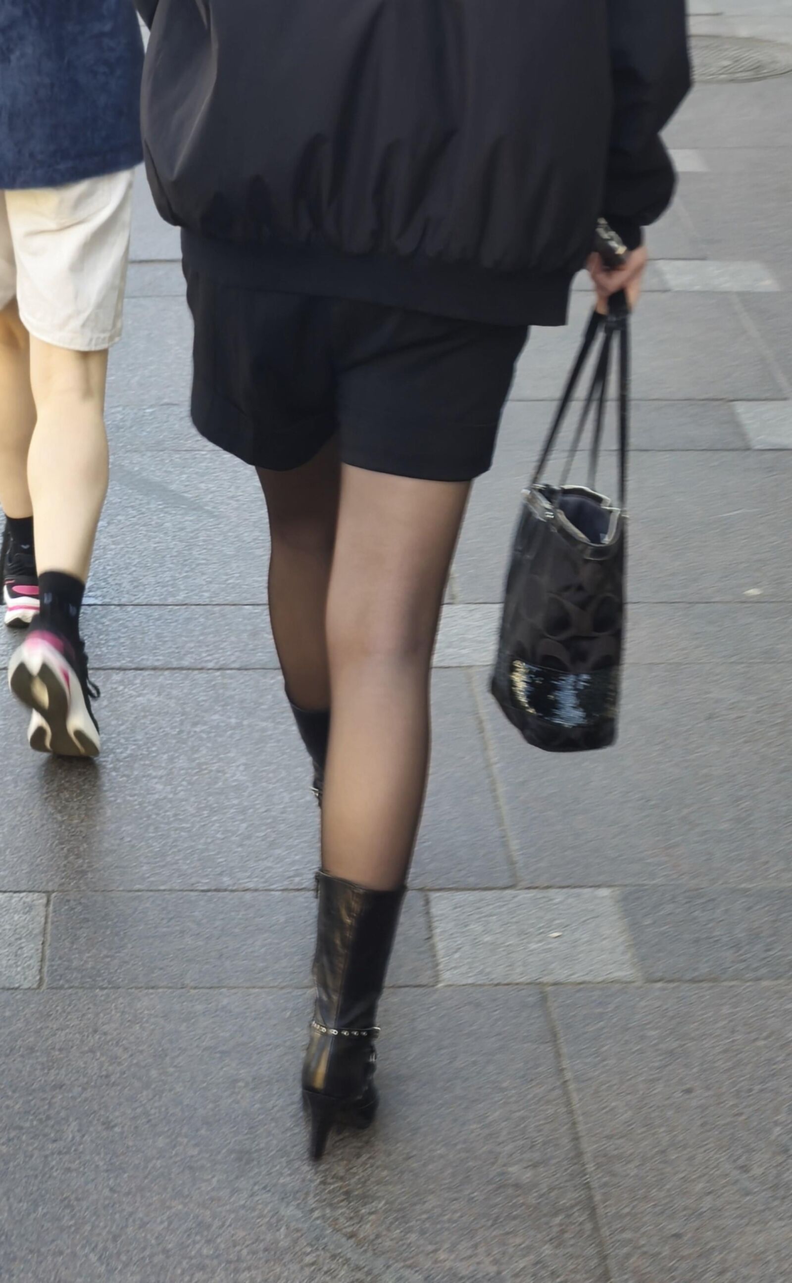Girl in black pantyhose and leather boots