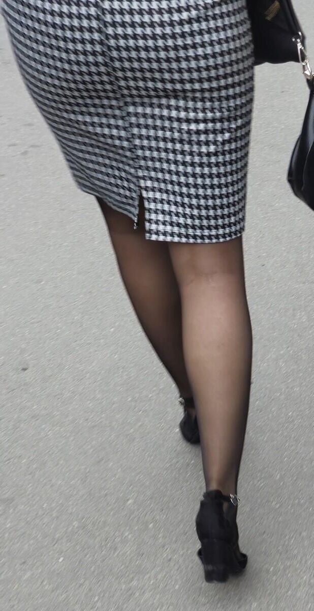Business woman in midi skirt, pantyhose and suede heels