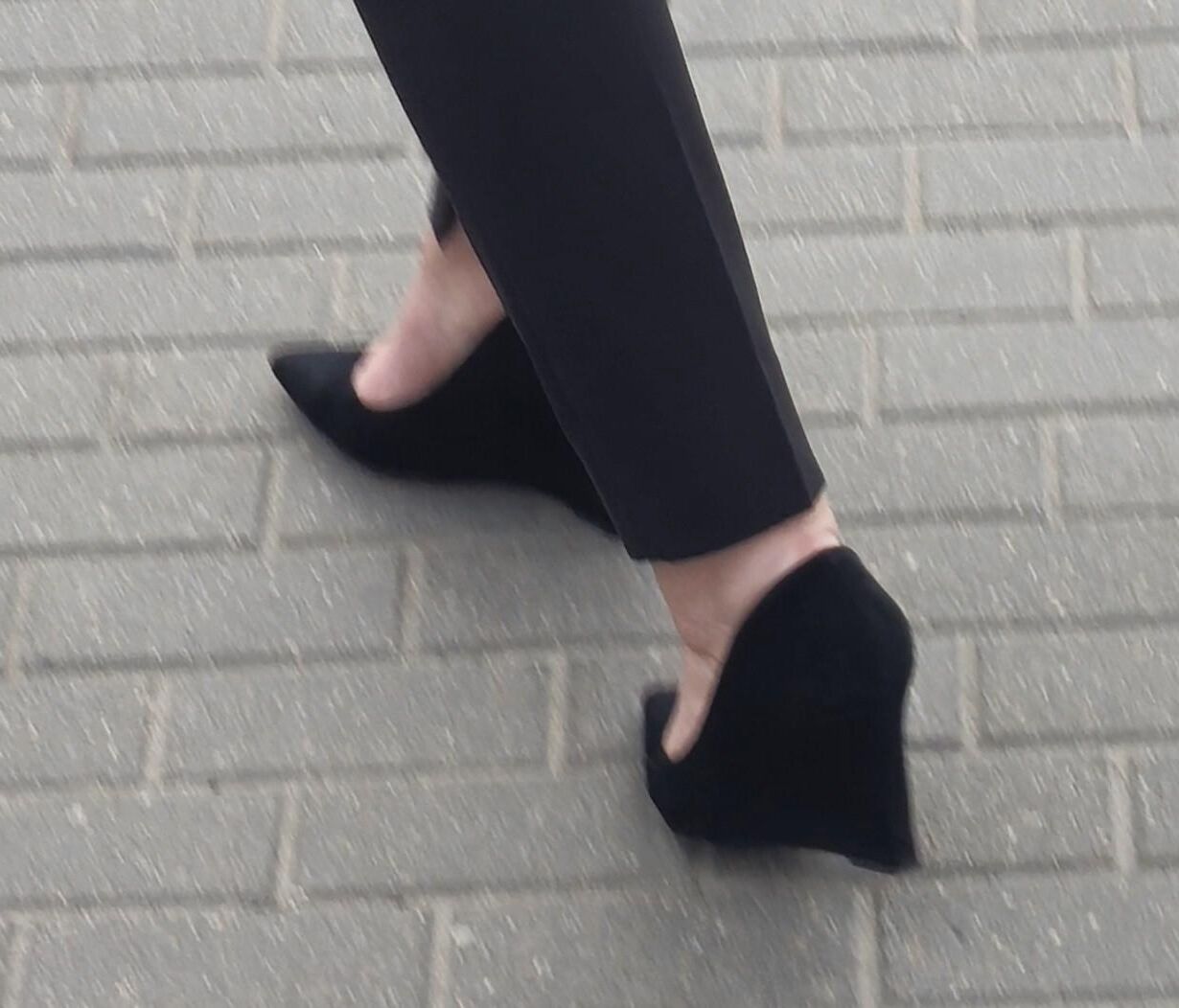 Woman in trousers and suede wedges heels