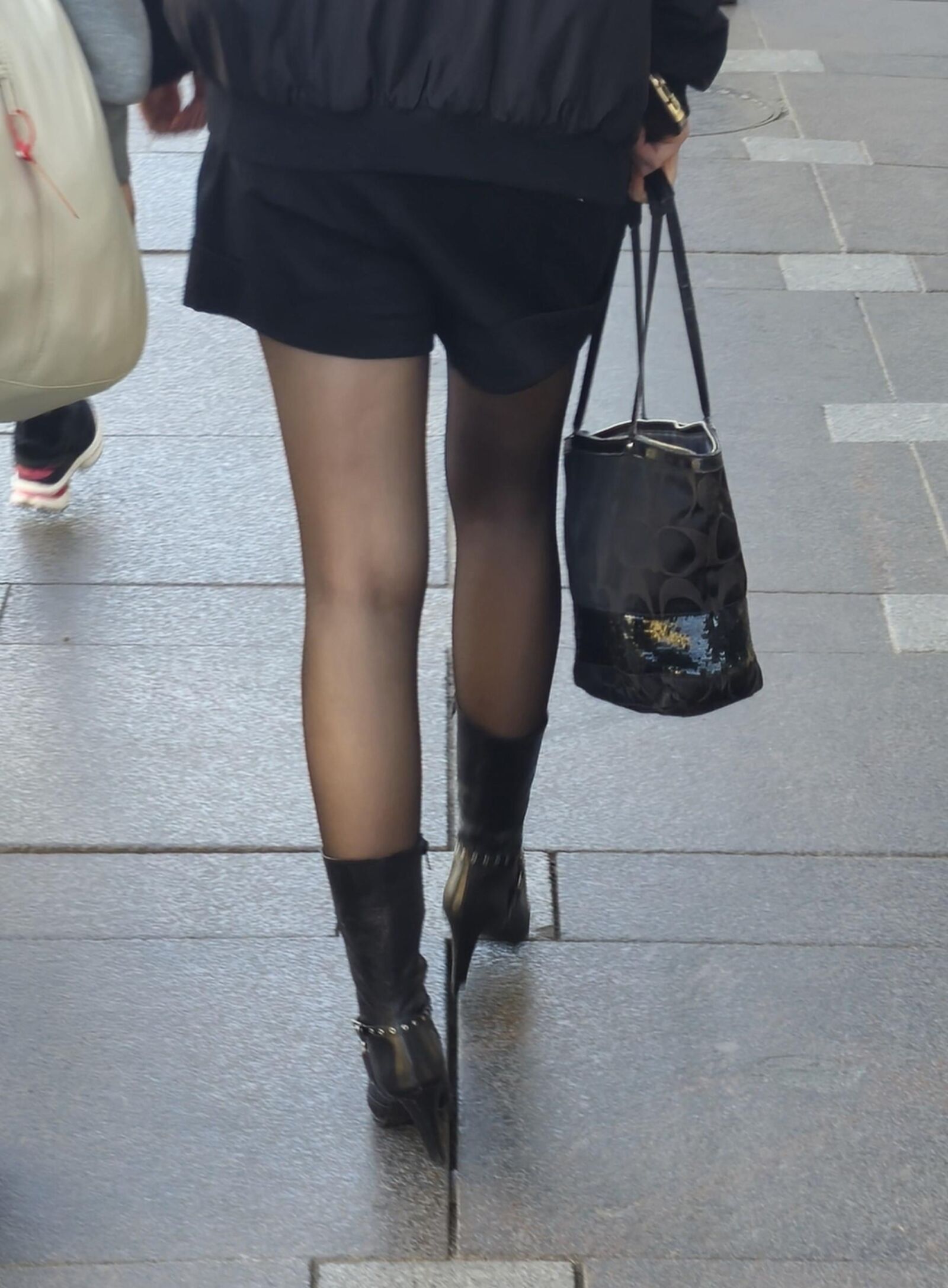 Girl in black pantyhose and leather boots