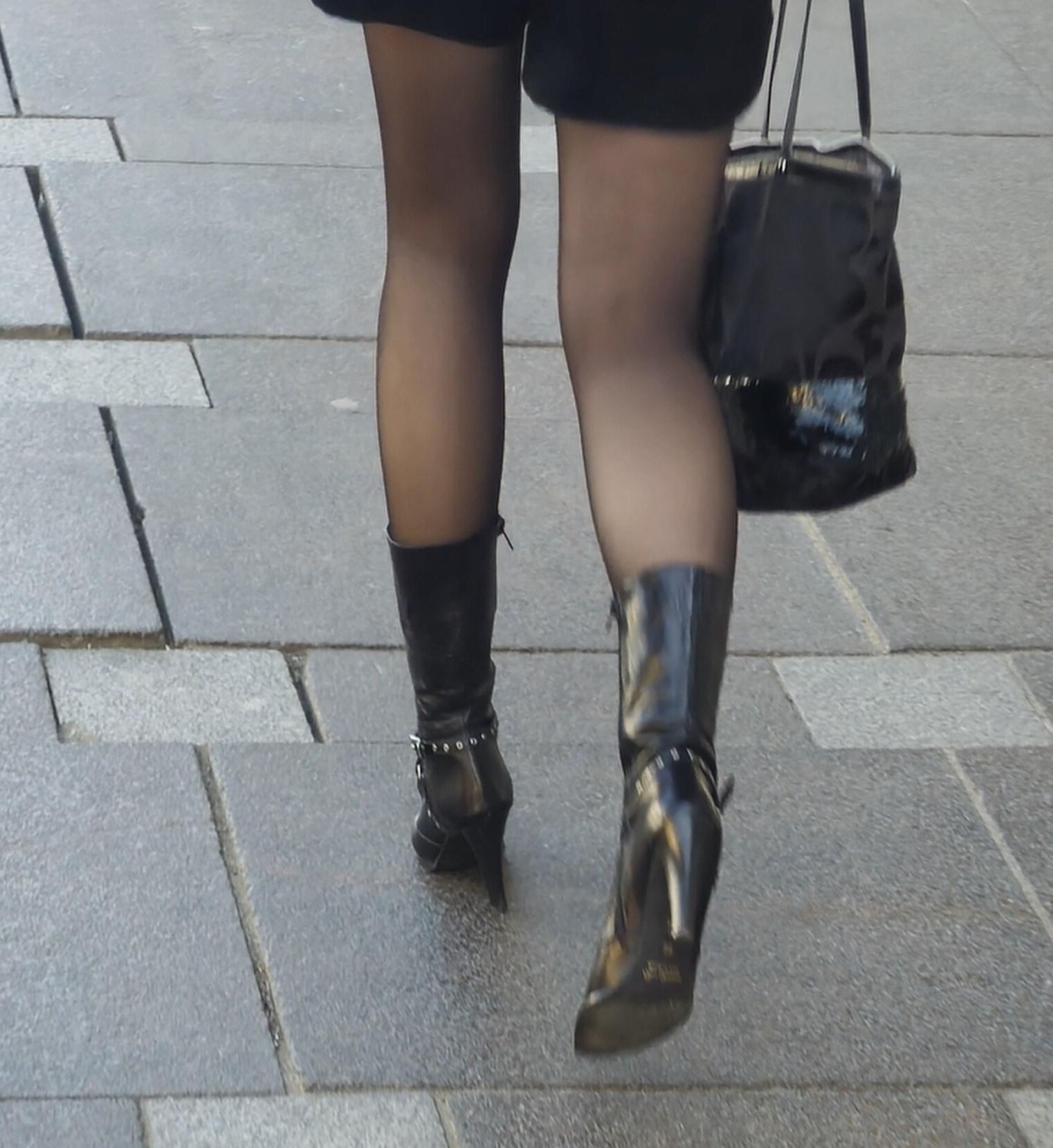 Girl in black pantyhose and leather boots