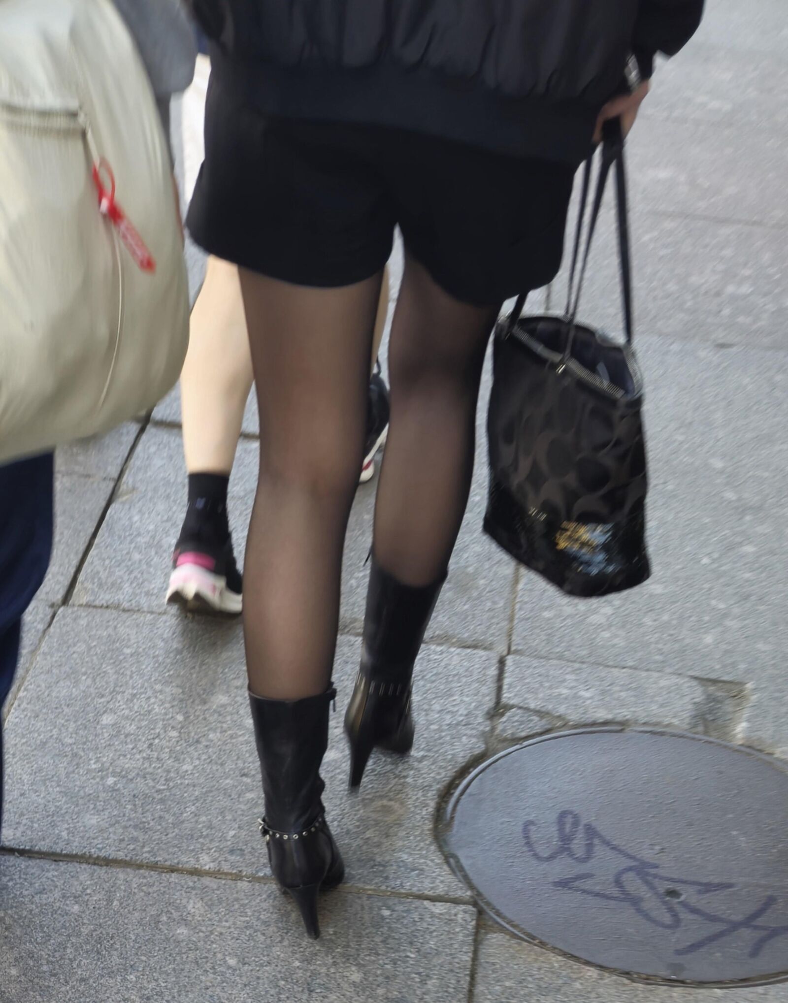Girl in black pantyhose and leather boots