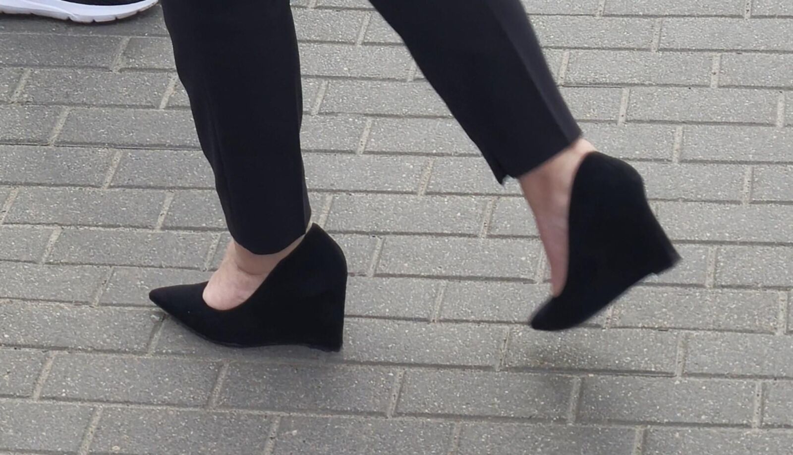Woman in trousers and suede wedges heels
