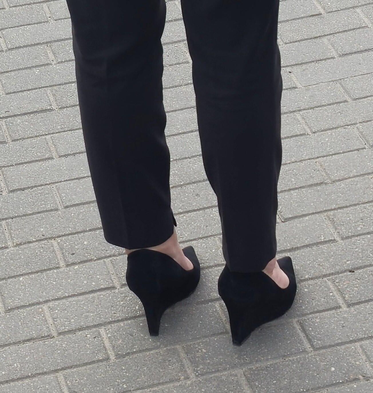 Woman in trousers and suede wedges heels