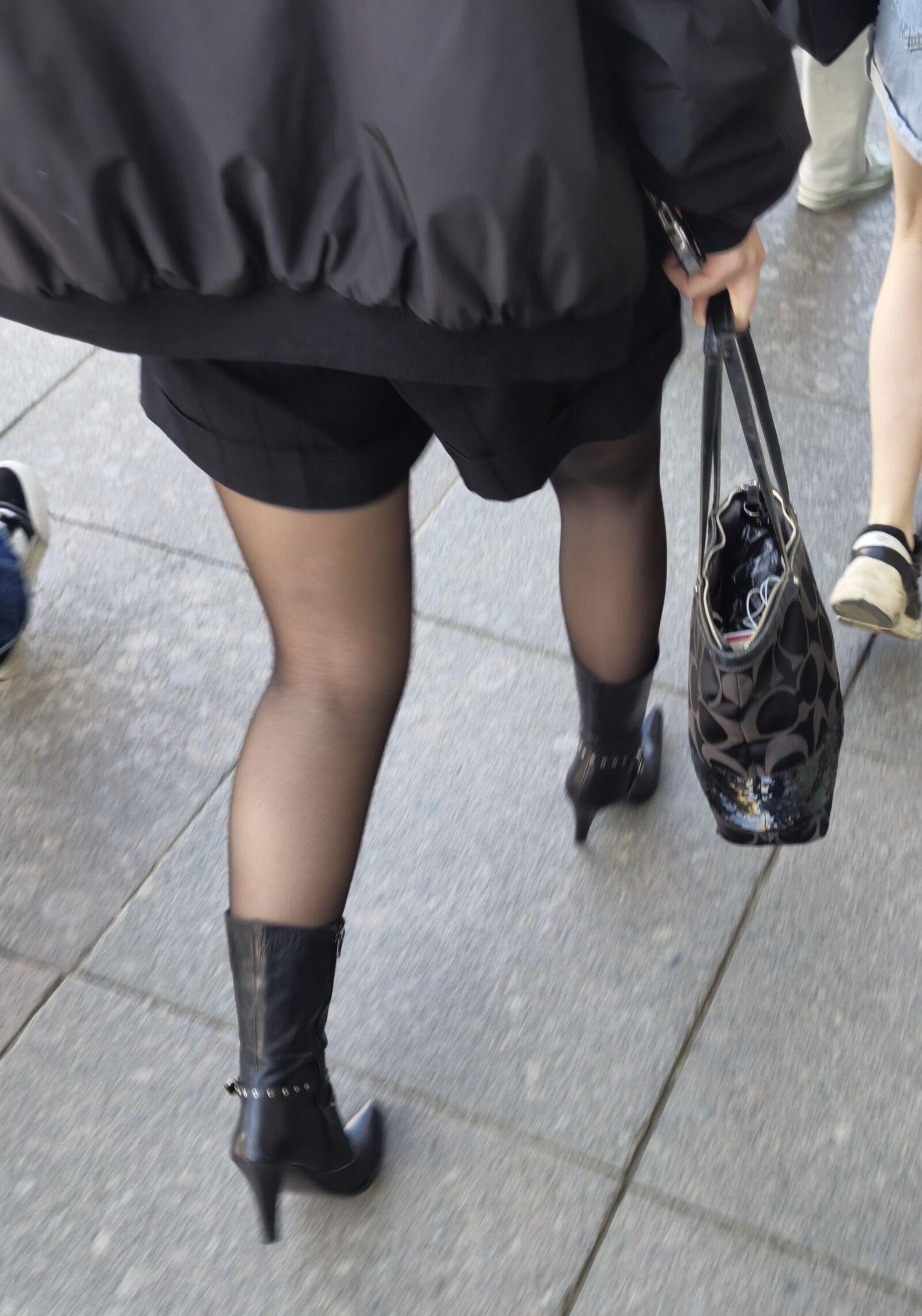 Girl in black pantyhose and leather boots