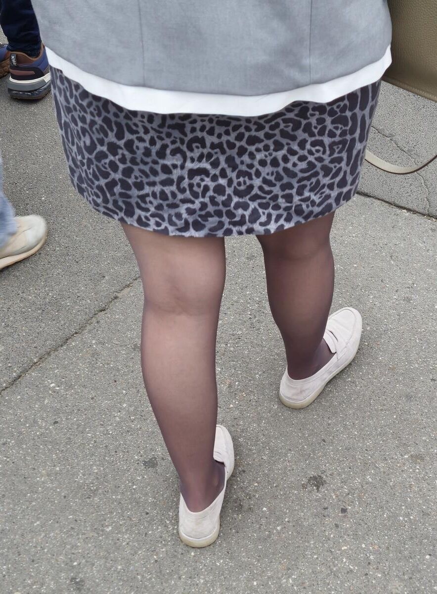 Woman in brown pantyhose and skirt