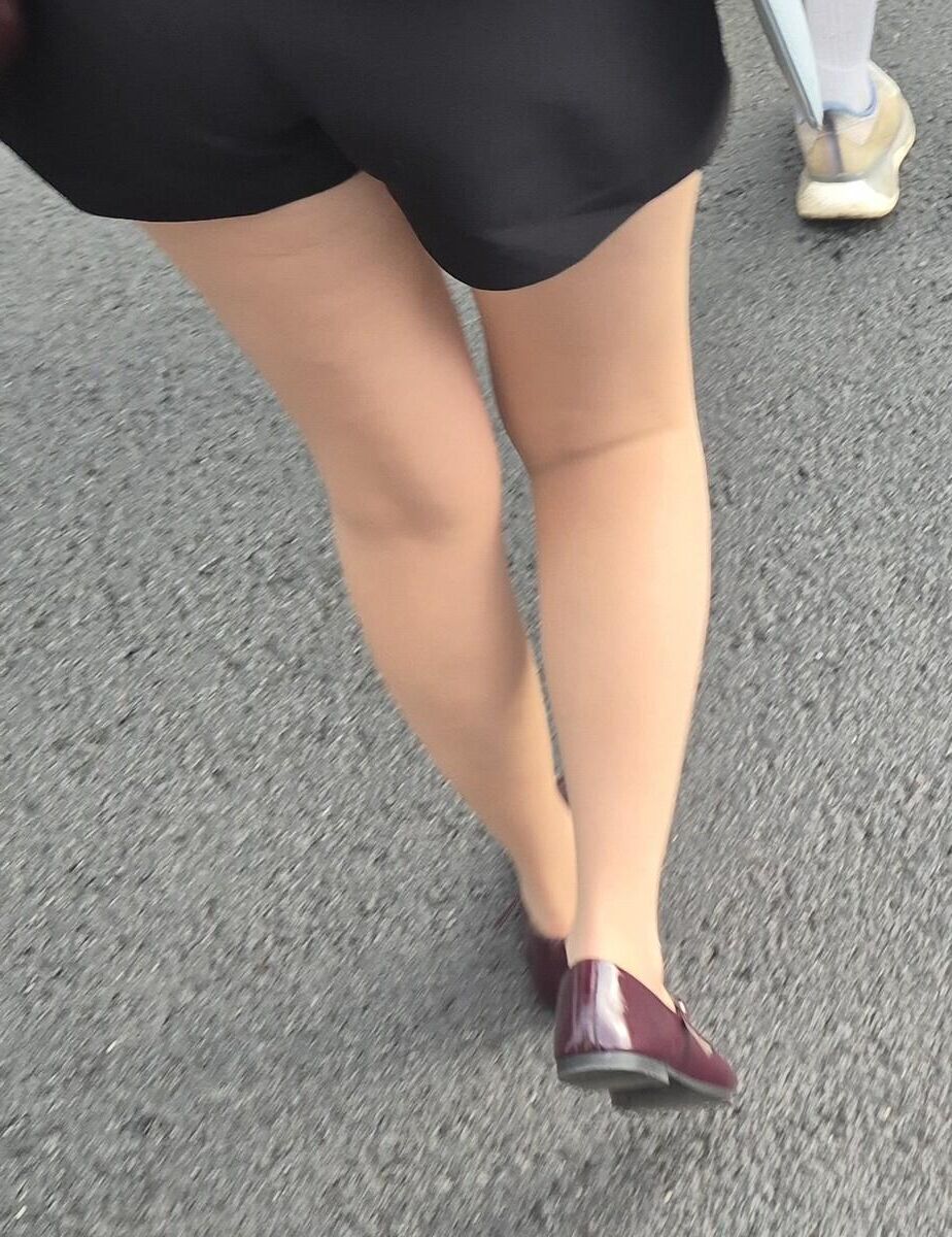 Girl in shorts, nude pantyhose and ballerinas shoes