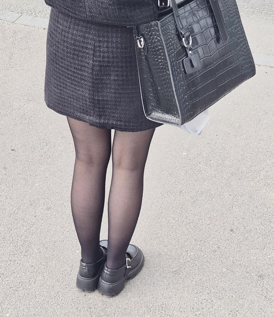 Girl in black pantyhose and mini skirt