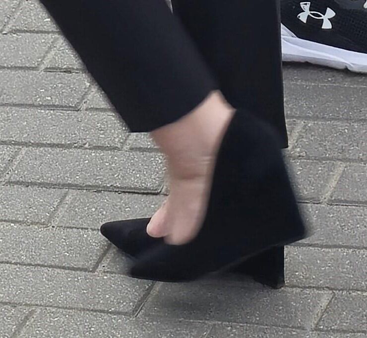 Woman in trousers and suede wedges heels